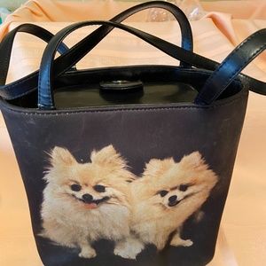 Very nice black purse showing two happy Poms